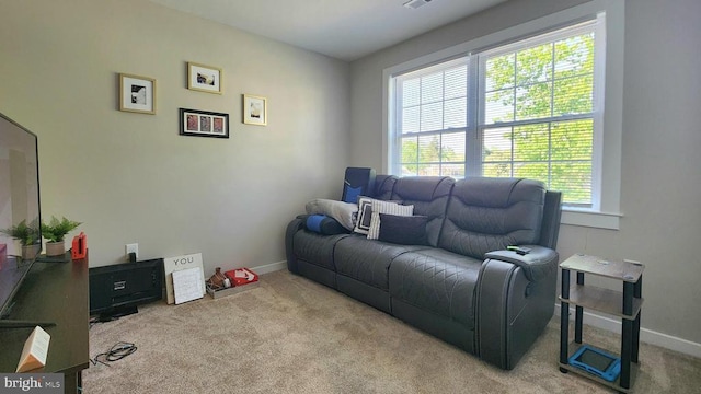 living area featuring carpet floors, baseboards, and visible vents