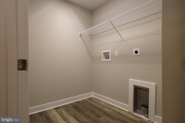 clothes washing area with laundry area, hookup for a washing machine, dark wood finished floors, baseboards, and hookup for an electric dryer