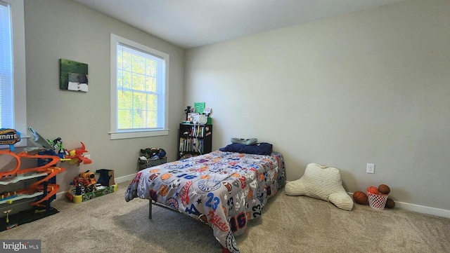 bedroom with carpet floors and baseboards