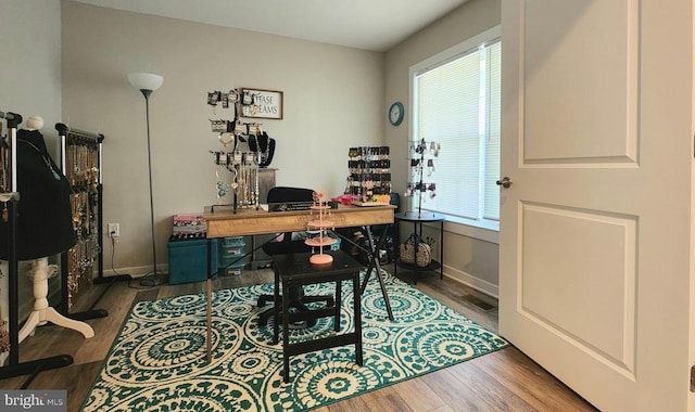 office space featuring baseboards and wood finished floors