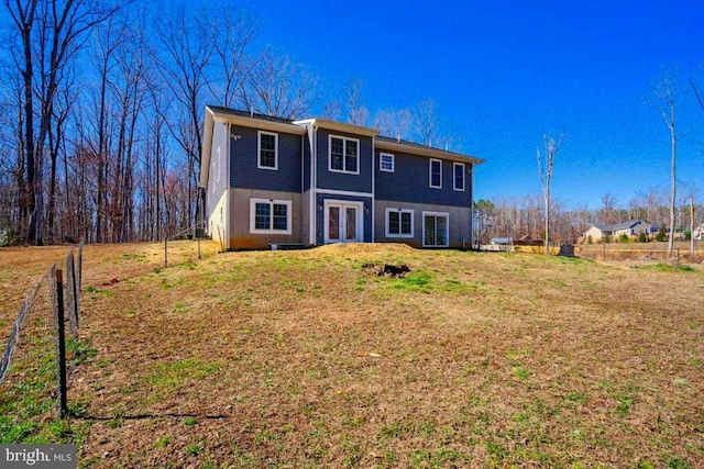 back of house with a lawn and french doors