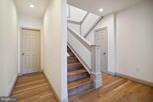 stairway featuring hardwood / wood-style flooring and a skylight