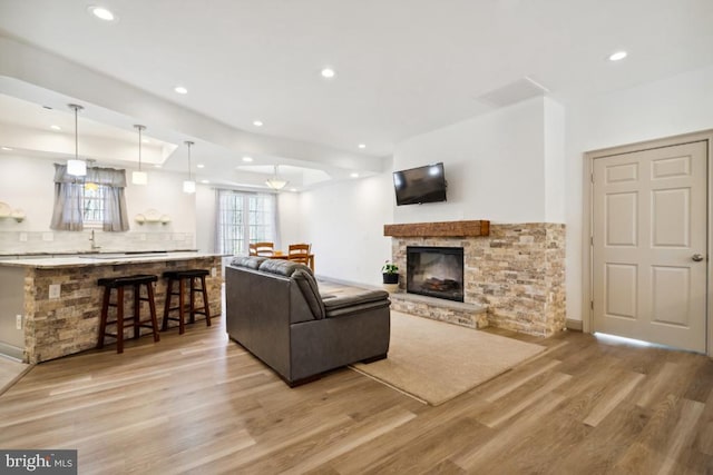 living room with a fireplace and light hardwood / wood-style floors