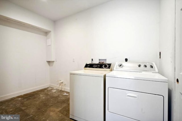 clothes washing area with washer and clothes dryer