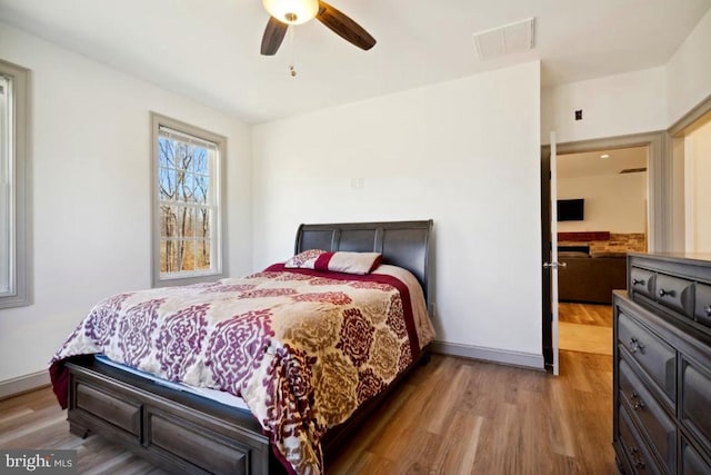 bedroom with wood-type flooring and ceiling fan