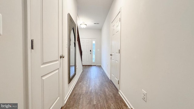 hall with dark wood-type flooring