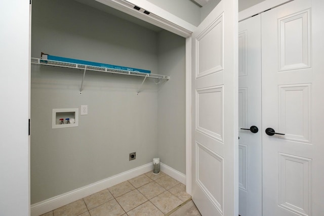 laundry area with light tile patterned floors, hookup for a washing machine, and hookup for an electric dryer