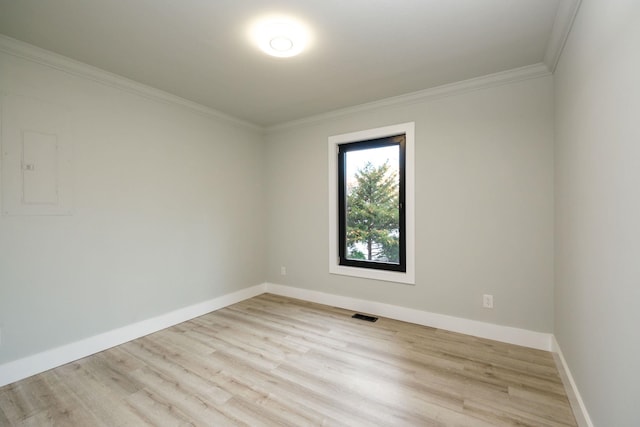 unfurnished room with crown molding, electric panel, and light wood-type flooring