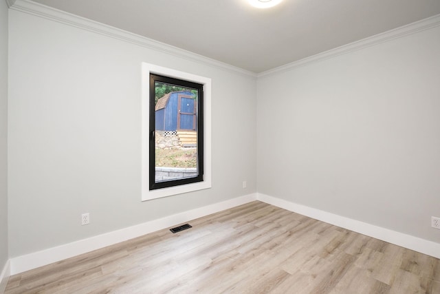 unfurnished room featuring ornamental molding and light hardwood / wood-style flooring