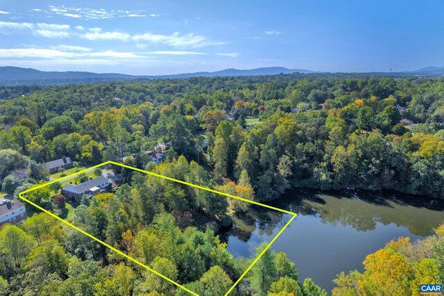 bird's eye view with a view of trees and a water and mountain view