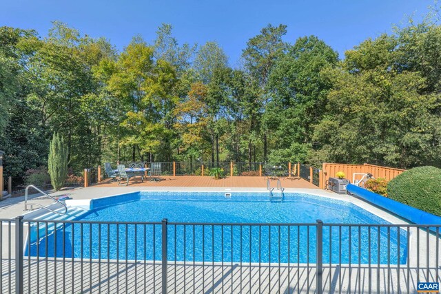 pool featuring a patio area and fence