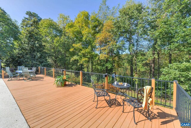 wooden terrace with outdoor dining area