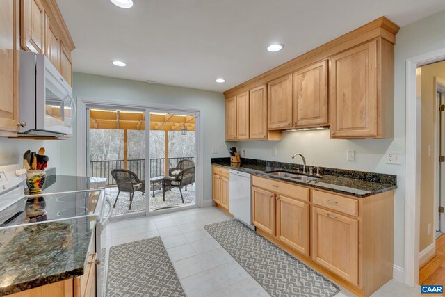 kitchen with white appliances, recessed lighting, light brown cabinetry, and a sink