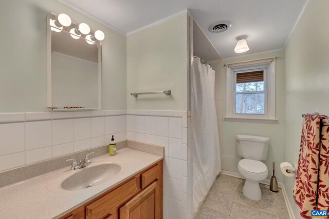 bathroom with visible vents, tile walls, toilet, tile patterned floors, and vanity