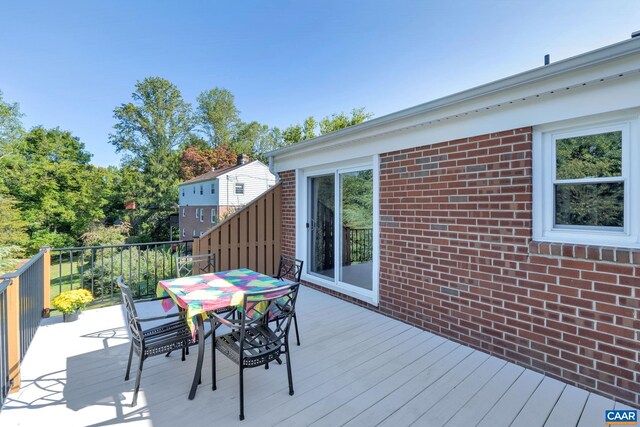 wooden terrace with outdoor dining space