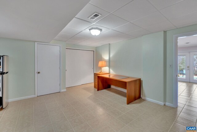 home office with visible vents, a paneled ceiling, baseboards, and french doors