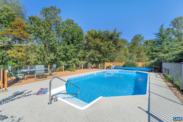 view of pool featuring a fenced in pool, a fenced backyard, and a patio area