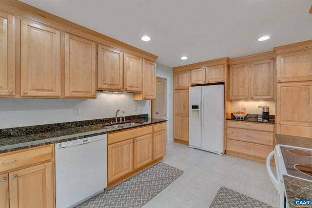 kitchen with light brown cabinetry, recessed lighting, white appliances, and a sink