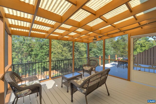 wooden terrace featuring outdoor dining space and a pergola