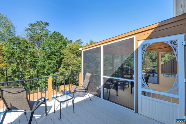 wooden deck featuring a sunroom