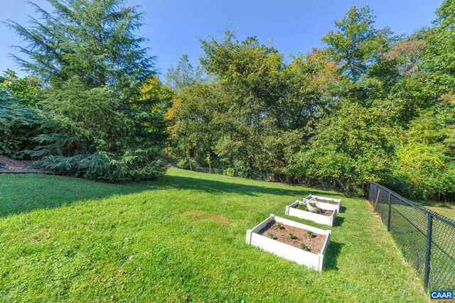 view of yard featuring a vegetable garden and fence