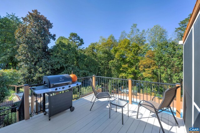 wooden deck featuring a grill