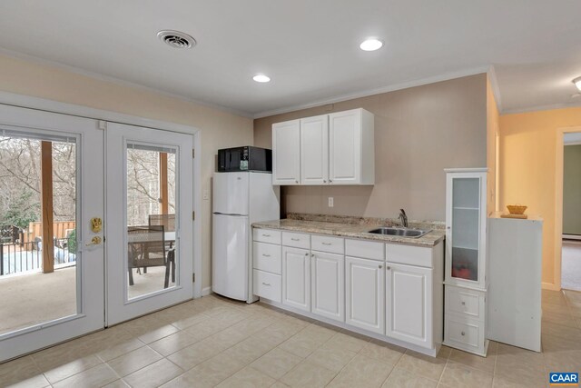 kitchen with visible vents, white cabinets, french doors, and freestanding refrigerator