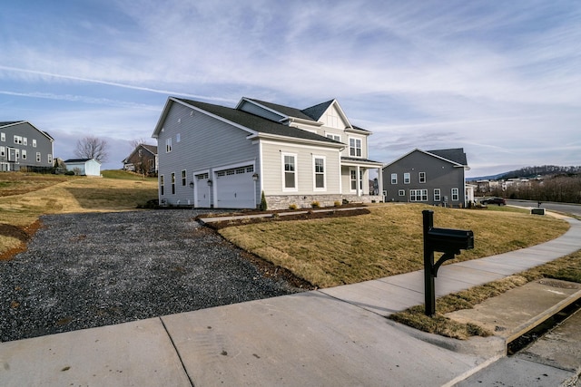 view of front facade with a garage and a front lawn