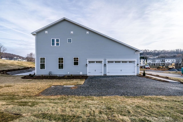 view of property exterior with a yard and a garage