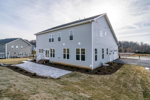 rear view of property featuring a lawn and a patio area