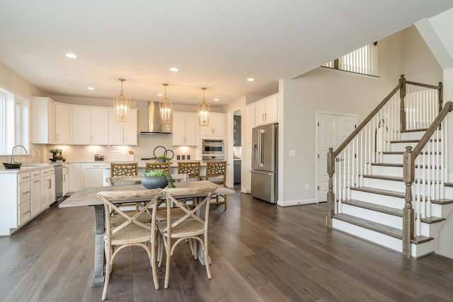 dining space featuring dark wood-type flooring and sink