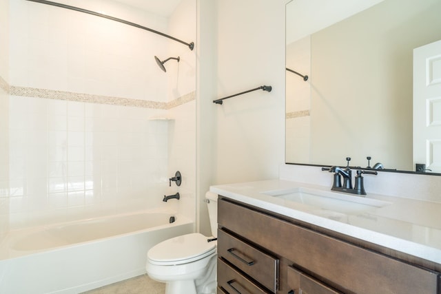 full bathroom with tiled shower / bath, vanity, and toilet