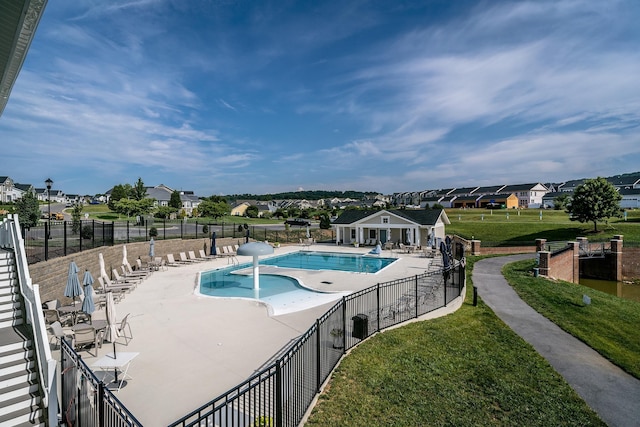 view of swimming pool featuring a patio area and a lawn