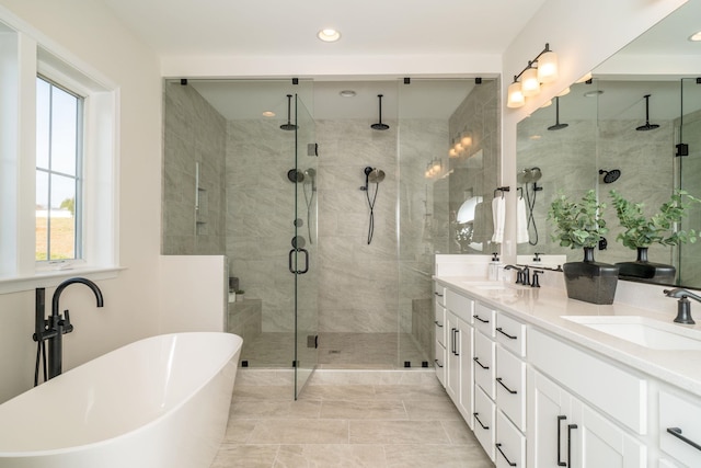 bathroom with vanity and separate shower and tub