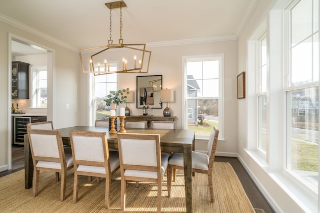 dining room with an inviting chandelier, wood-type flooring, ornamental molding, and beverage cooler