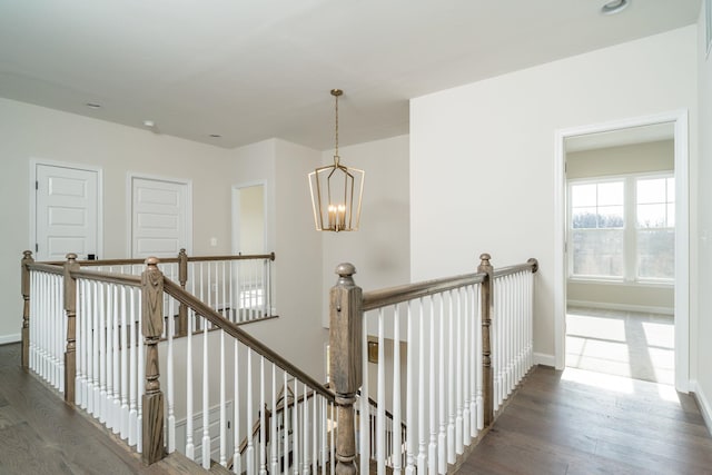 hall featuring a notable chandelier and dark hardwood / wood-style floors