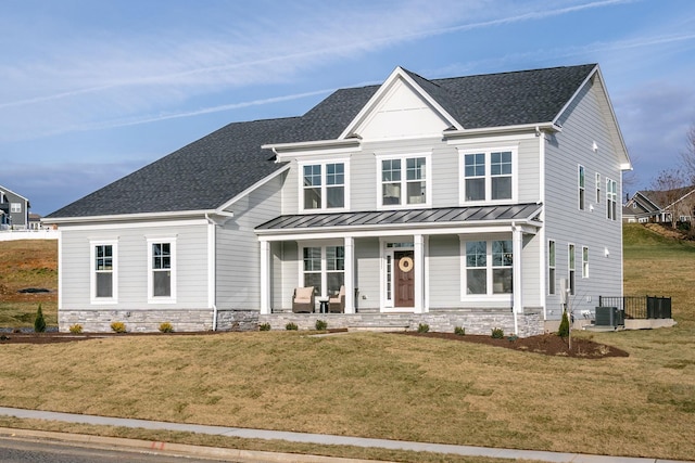 view of front of property featuring a front lawn, central air condition unit, and covered porch