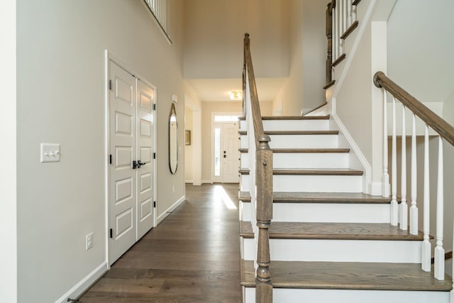 entrance foyer with a high ceiling and dark hardwood / wood-style flooring