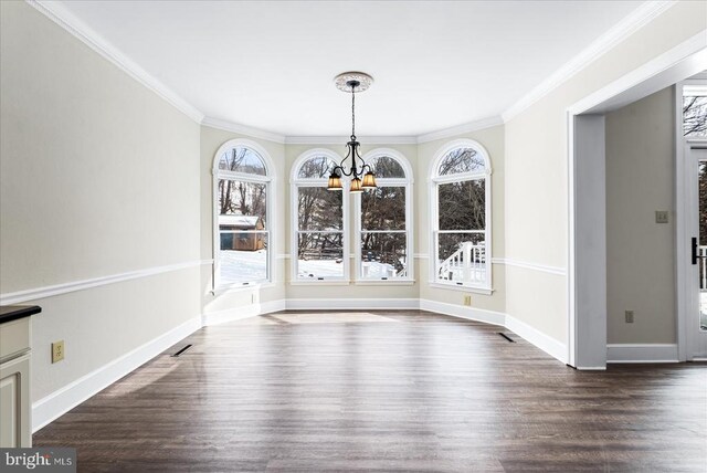 unfurnished dining area featuring an inviting chandelier, ornamental molding, dark wood-type flooring, and a wealth of natural light