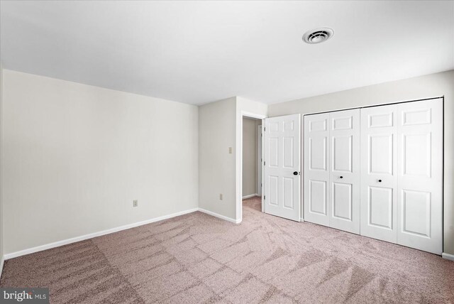 unfurnished bedroom with carpet flooring and a closet