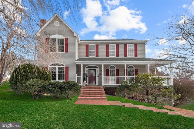 view of front of house featuring a porch and a front yard