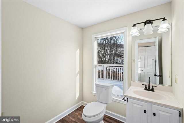 bathroom featuring vanity, hardwood / wood-style floors, and toilet