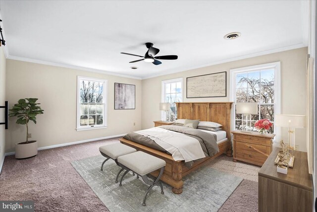 carpeted bedroom featuring crown molding and ceiling fan