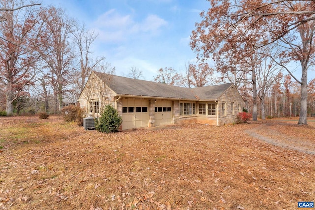 view of front of property featuring a garage and central AC unit