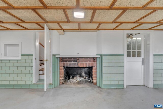 unfurnished living room featuring concrete flooring and a fireplace