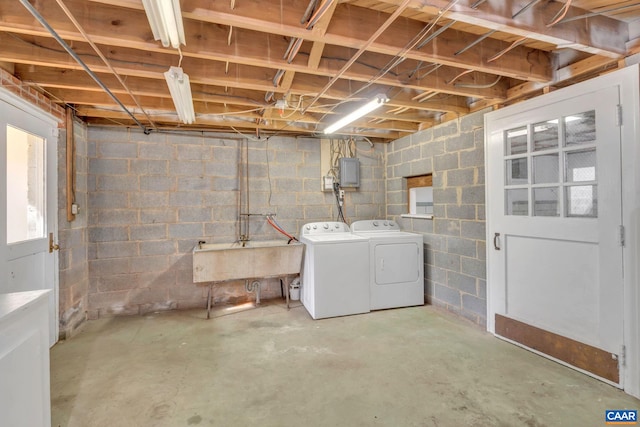 basement featuring washer and dryer and sink