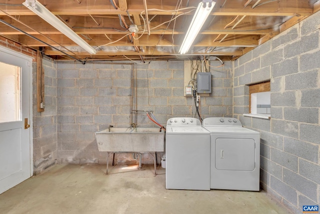 interior space featuring electric panel, separate washer and dryer, and sink