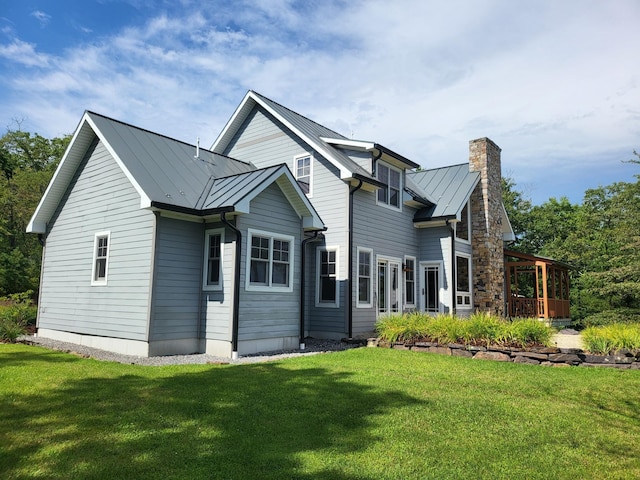 rear view of house featuring a yard