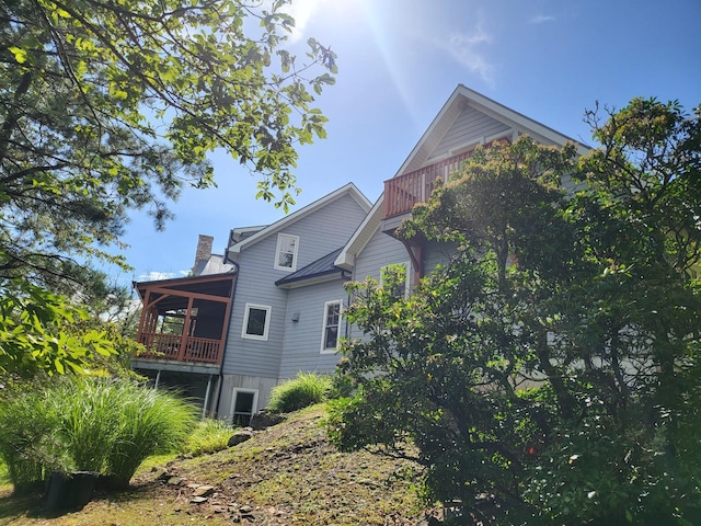 view of side of property with a balcony