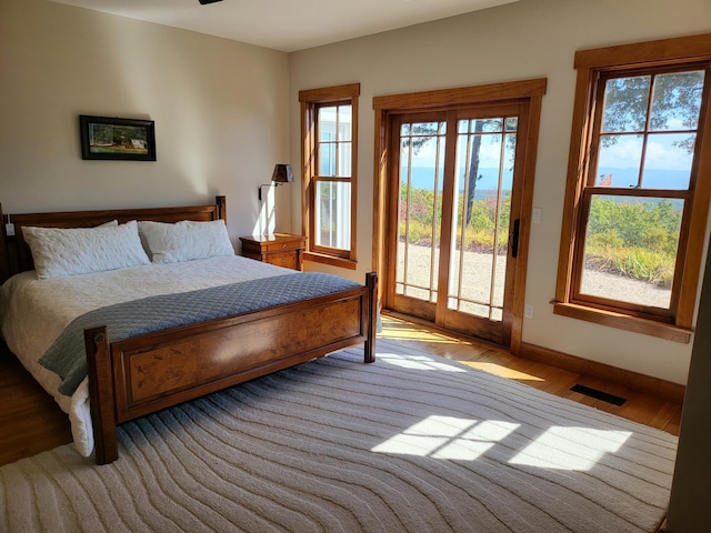 bedroom featuring light hardwood / wood-style flooring and access to outside